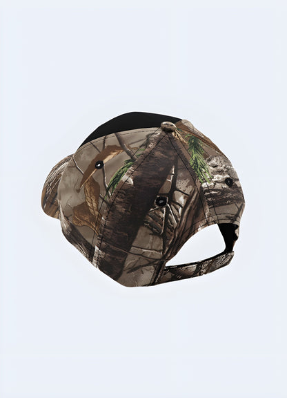 A back-side view of a camo-patterned cap with "Reaper Crew" text on the front. The camouflage design covers the entire cap, and the back features an adjustable strap for a custom fit.