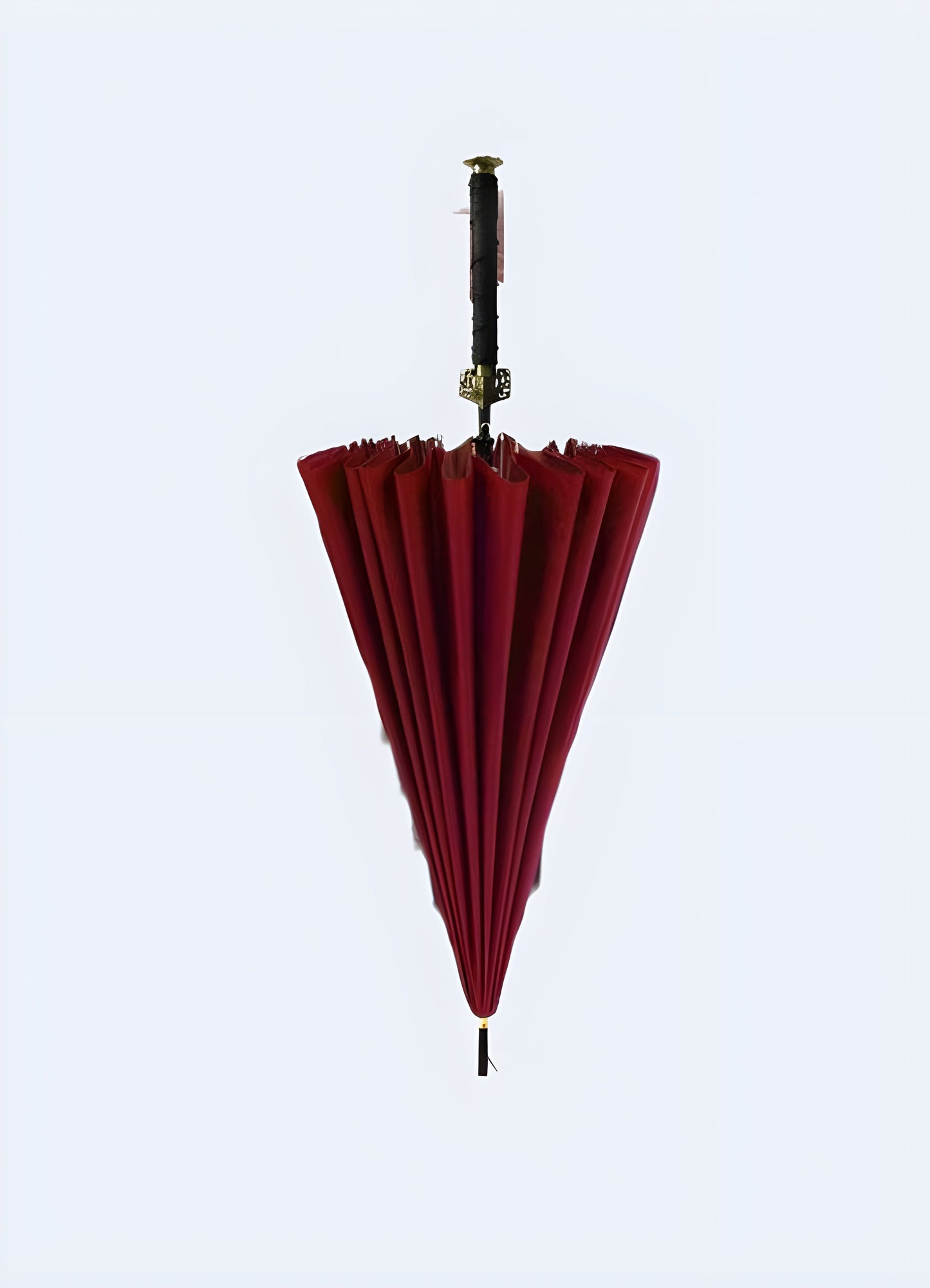 Front view of a red samurai sword umbrella. The handle mimics a sword’s hilt, and the canopy is designed to resemble a sword blade Canada.