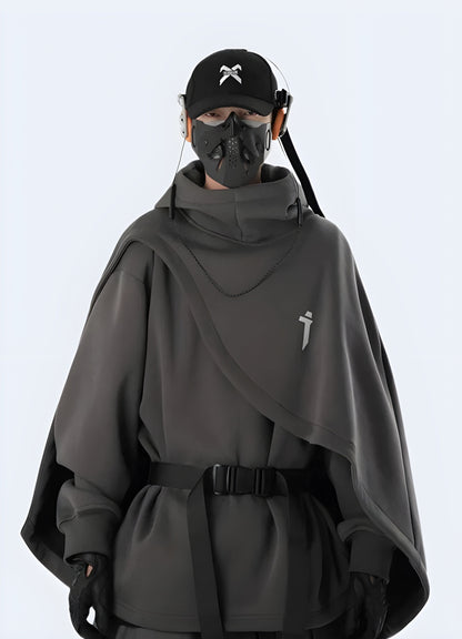 A person wearing a futuristic grey sci-fi poncho in a Canadian urban setting, showcasing the garment's innovative design and functionality for city exploration.