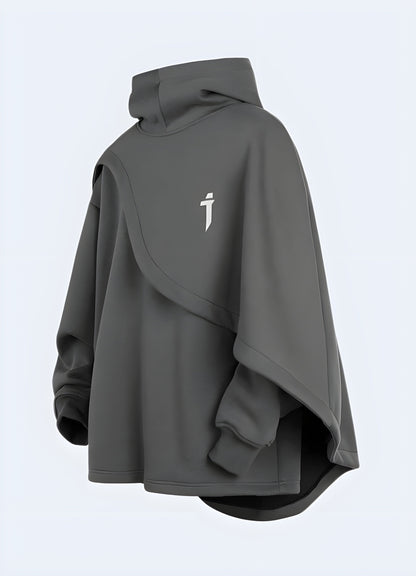 Side view of a man wearing a sleek black sci-fi poncho on a Canadian city street, highlighting the garment's modern style and adaptability for urban adventures.