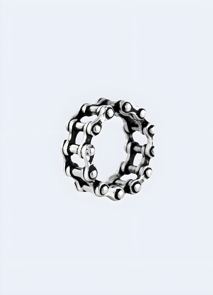 A close-up front-side view of a silver chain ring, showcasing its intricate linked chain design Canada.