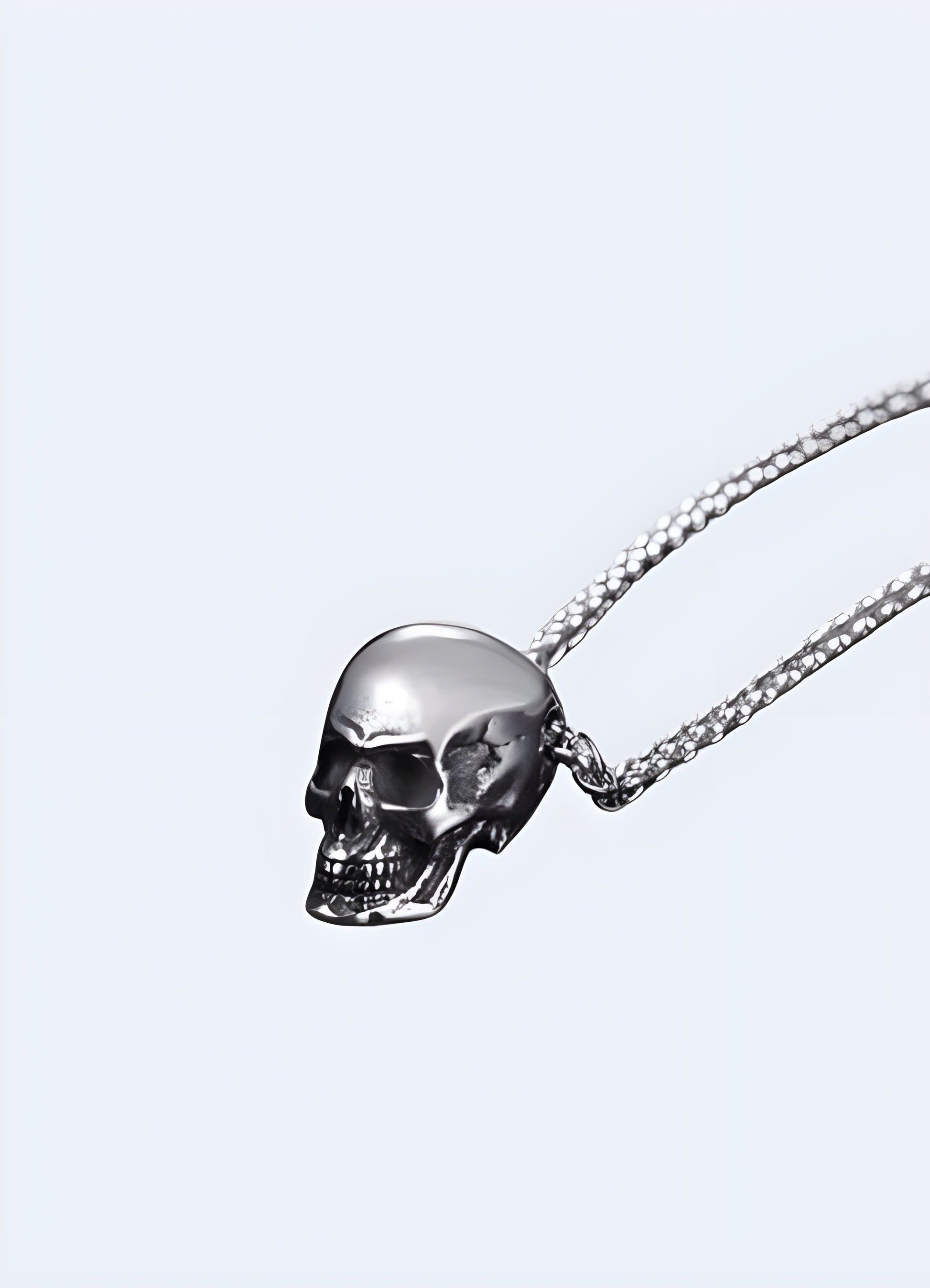 A silver skeleton necklace seen from the side, highlighting its detailed craftsmanship and unique skeletal design, set against a simple background to emphasize its distinct style Canada.