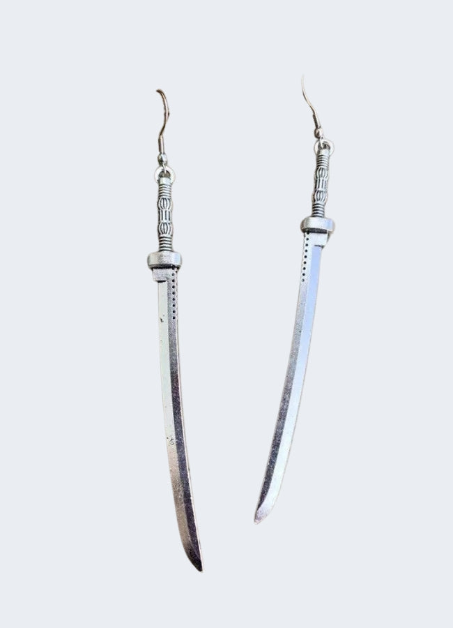 Close view of the Sword Earrings blade shape, defined crossguard and pointed tip
