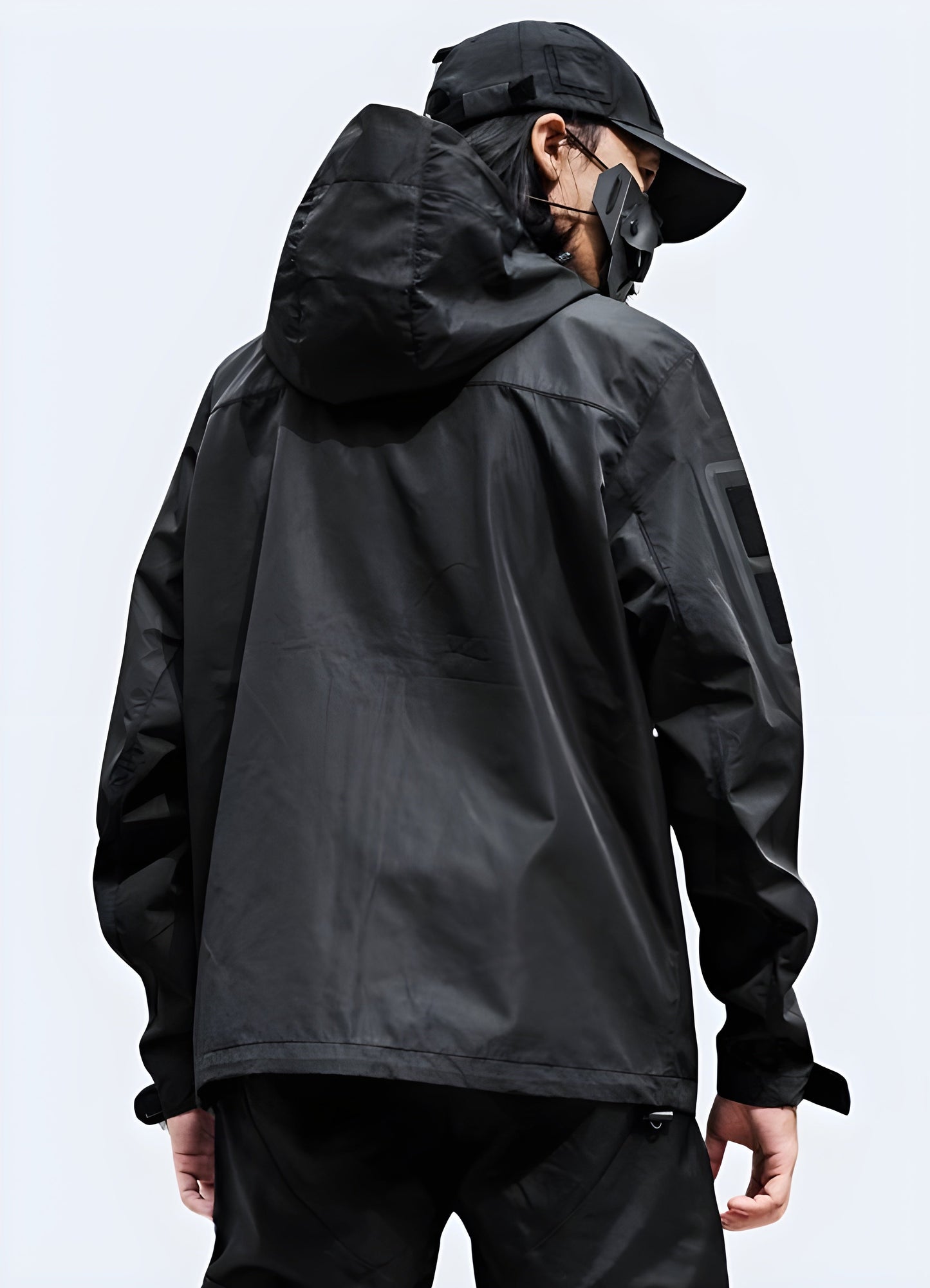 Back side view of a tactical jacket showcasing its multiple utility pockets, adjustable elements, and rugged construction, perfect for storing essentials while navigating Canada's urban landscapes and varying weather conditions in comfort and style.