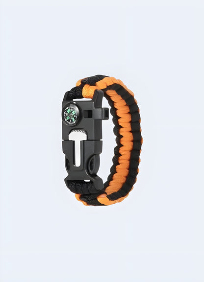 Tactical paracord bracelet 5-in-1 in orange and black from the Canada, featuring a multi-functional design with integrated survival tools.