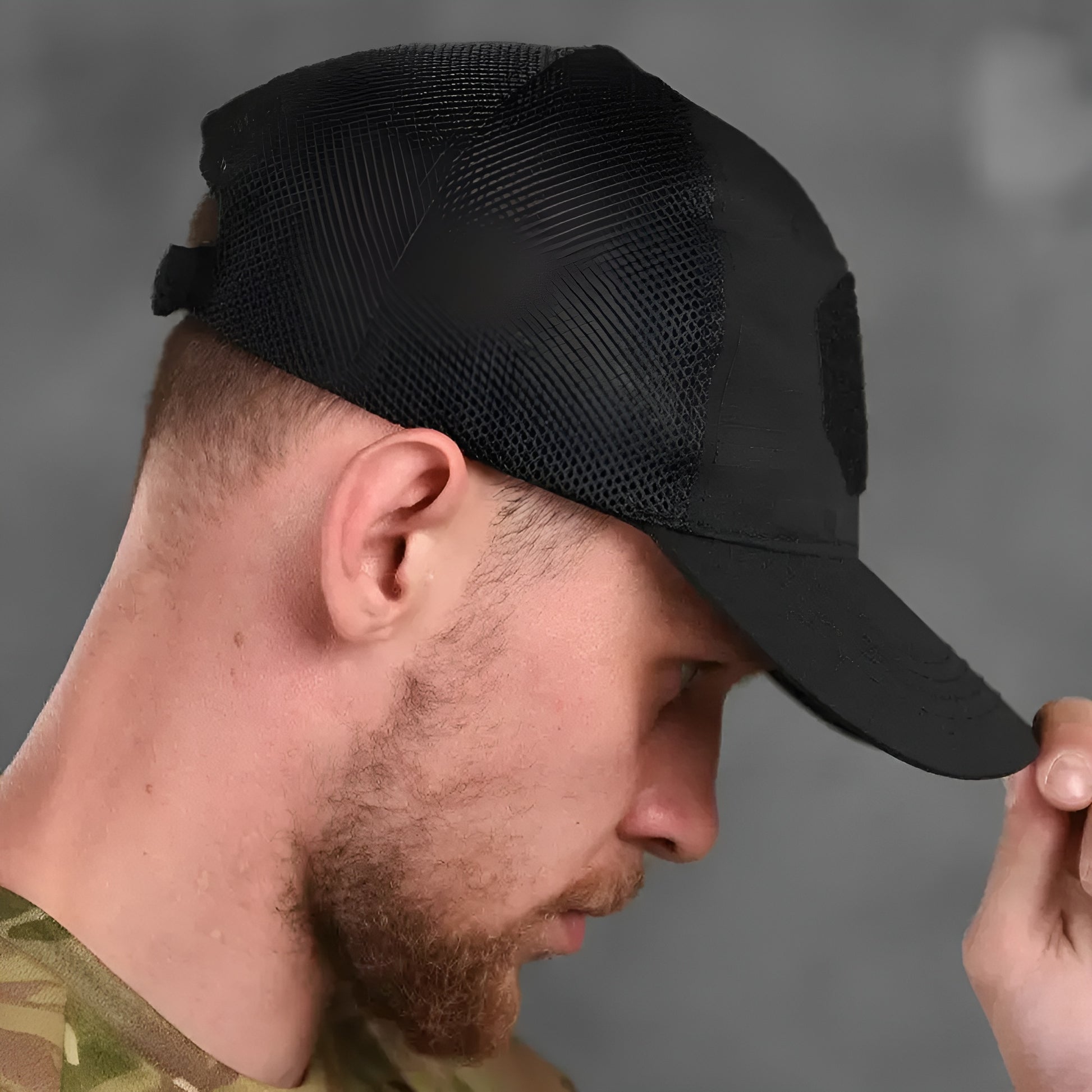 A model wearing a black tactical skull cap, shown from the side to highlight the cap’s snug fit and streamlined, utilitarian design.