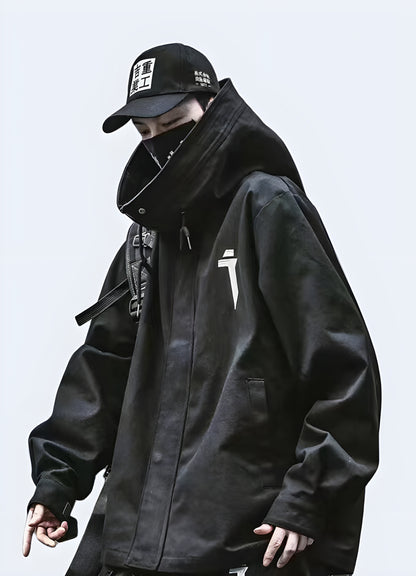 Man wearing a black techwear anorak jacket, front view, showcasing its practicality and fashion-forward design for Canadian urban landscapes.