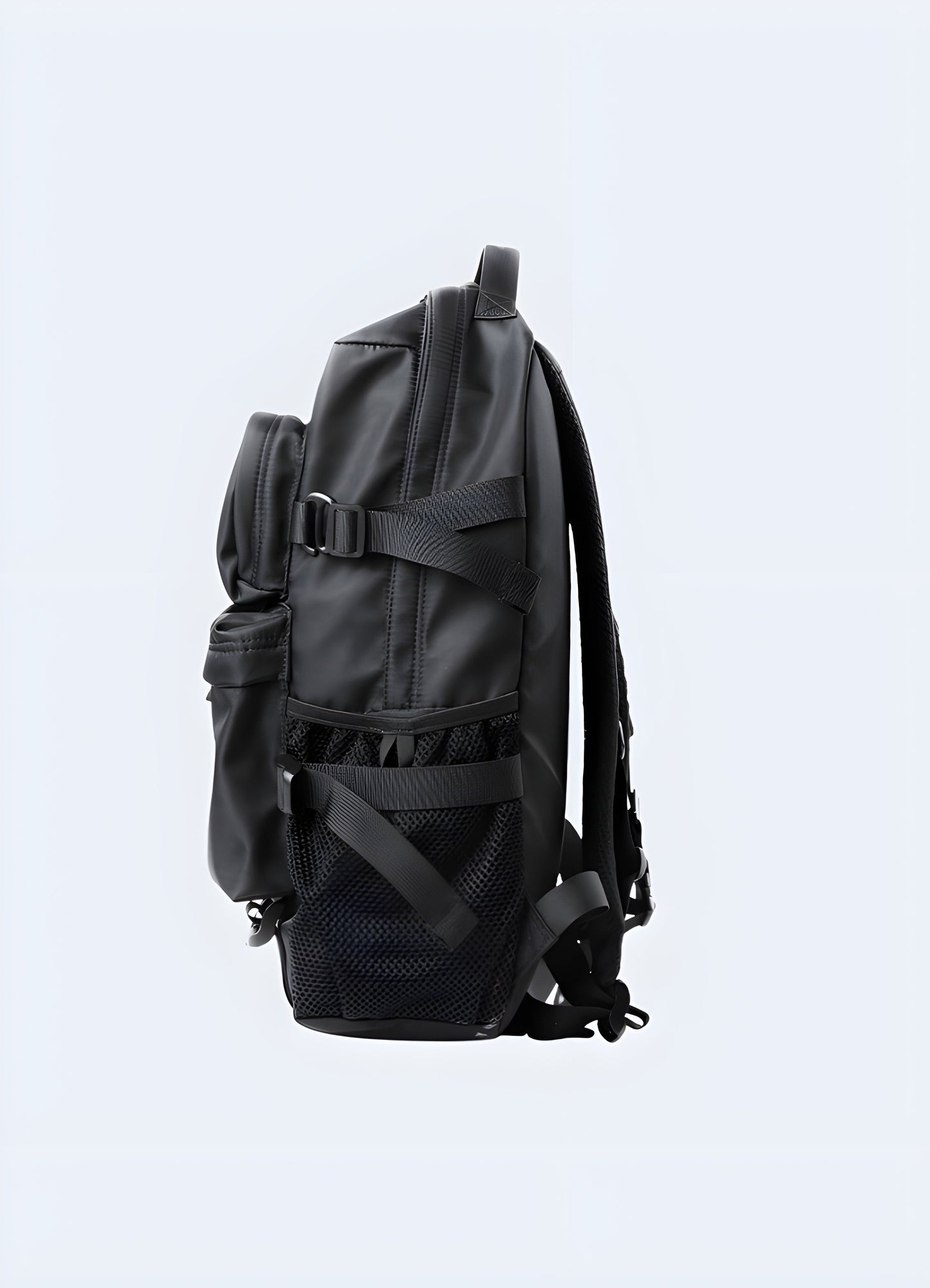 Side view of a model wearing a techwear backpack. The backpack is sleek with a matte black finish, featuring a streamlined profile and side pockets Canada. 