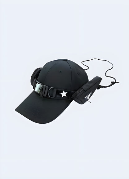 A techwear baseball cap featuring a functional buckle pocket and two attached bags, displayed from the side to showcase the cap’s multi-functional design Canada.