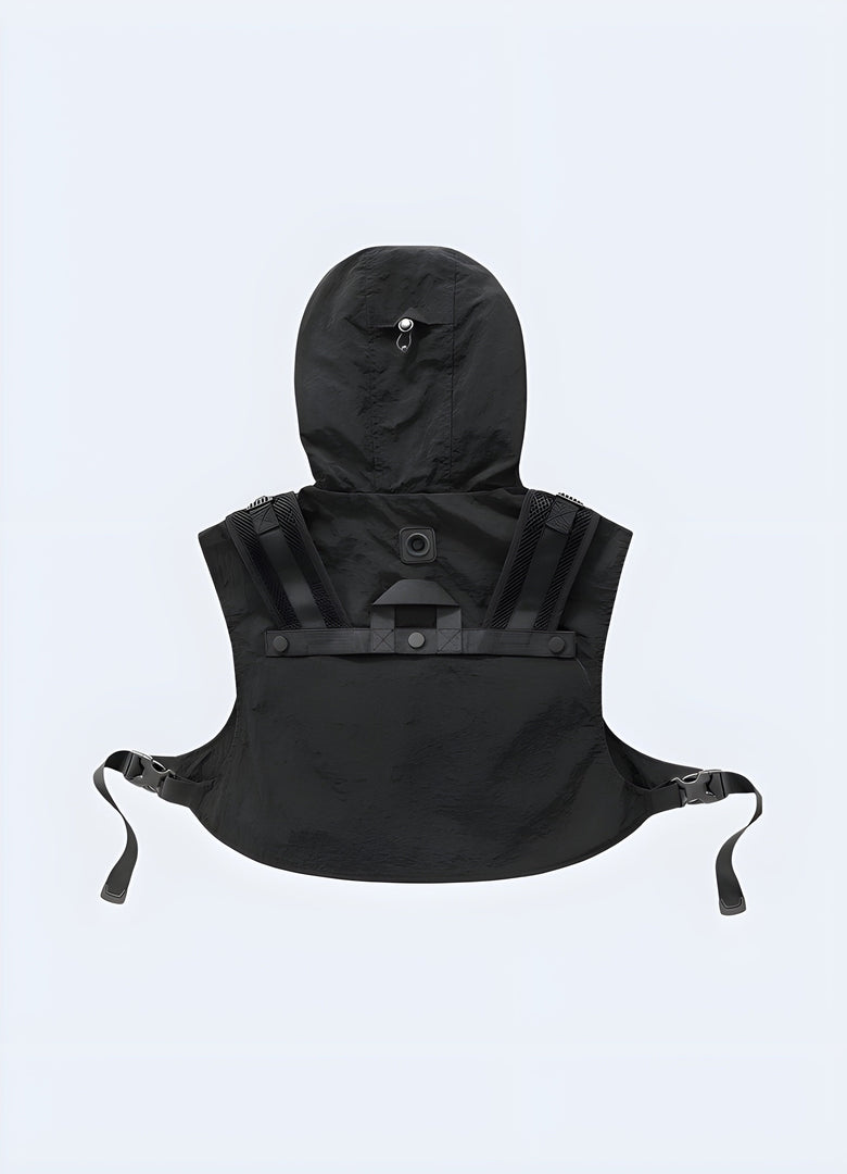 Rear view of a model sporting a black techwear hood cropped vest featuring a sleek design, adjustable straps, and a streamlined fit for enhanced functionality and style.
