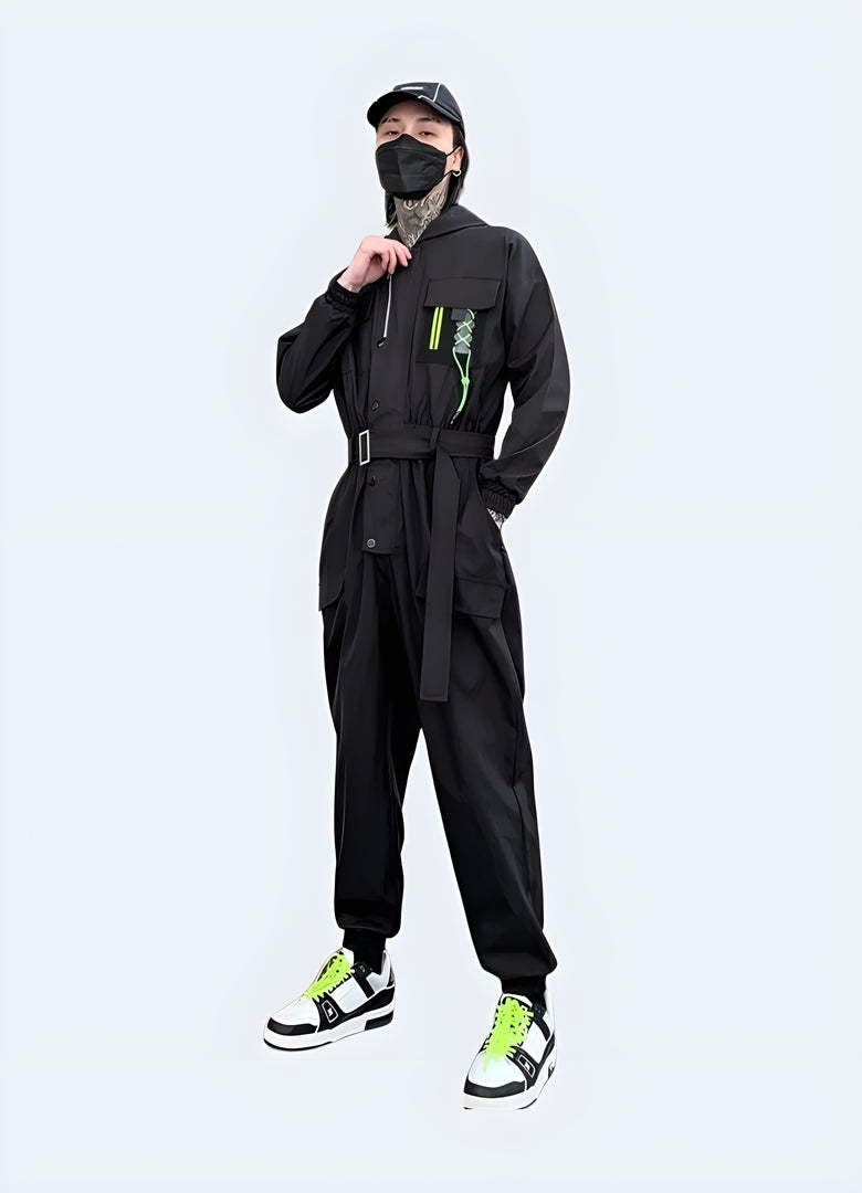 Futuristic black techwear jumpsuit with cargo pockets and straps, worn by a man in an urban Canadian setting, photographed from behind.