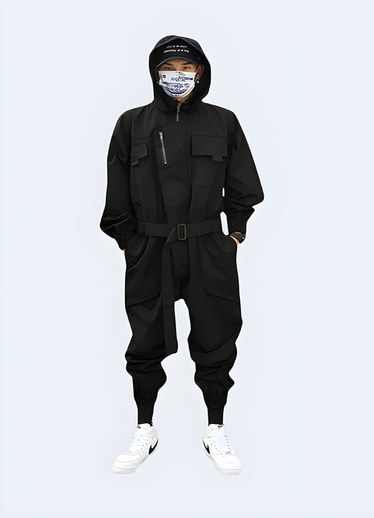 Futuristic black techwear jumpsuit with cargo pockets and straps, worn by a man in an urban Canadian setting, photographed from behind.