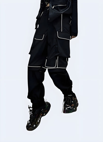 Front view of a woman wearing black reflective cargo pants, highlighting the techwear aesthetic and functionality for urban exploration in the Canada.