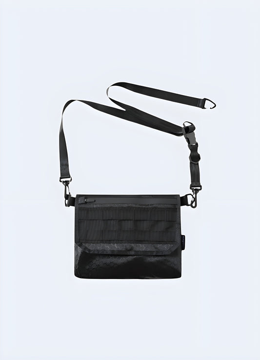 The bag features a sleek, black design with minimalistic details and adjustable straps. Its modern, urban style complements the model's outfit, set against a simple, neutral background  Canada.