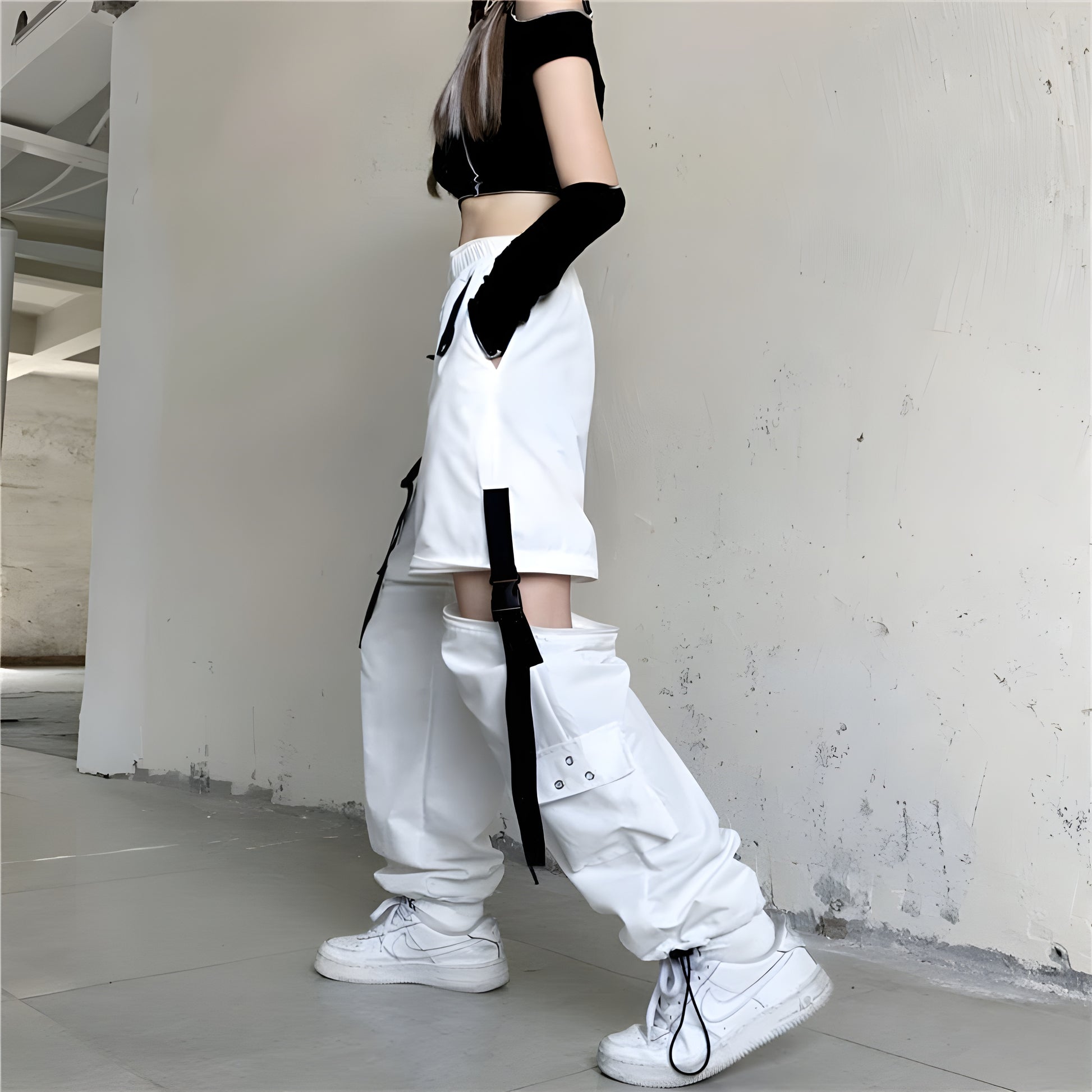 Female model showcasing the side view of women's techwear white pants, emphasizing the contemporary design and functional features, perfect for the Canada market.