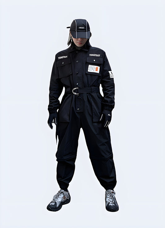 Futuristic black techwear workwear with multiple pockets and straps, worn by a man in an urban Canadian setting, photographed from behind.