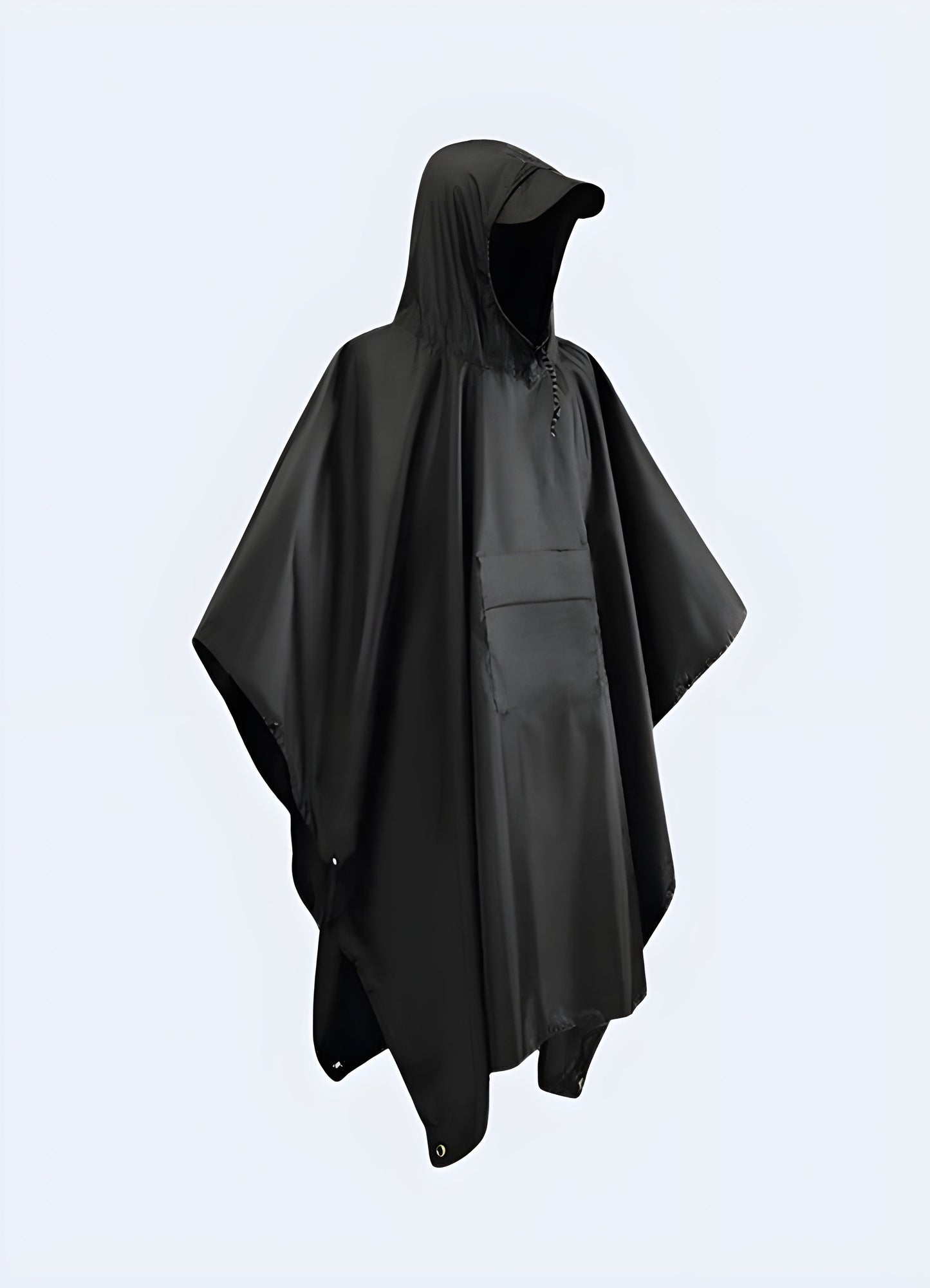 A person wearing a high-performance waterproof techwear poncho in a rainy Canadian environment, showcasing the garment's functionality and protection against the elements.