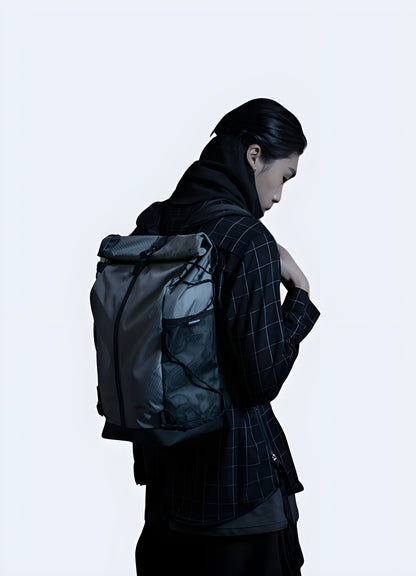 Front-side view of a person wearing a dark grey comeback backpack. The bag features a sleek design and is worn across the shoulders with adjustable straps Canada.