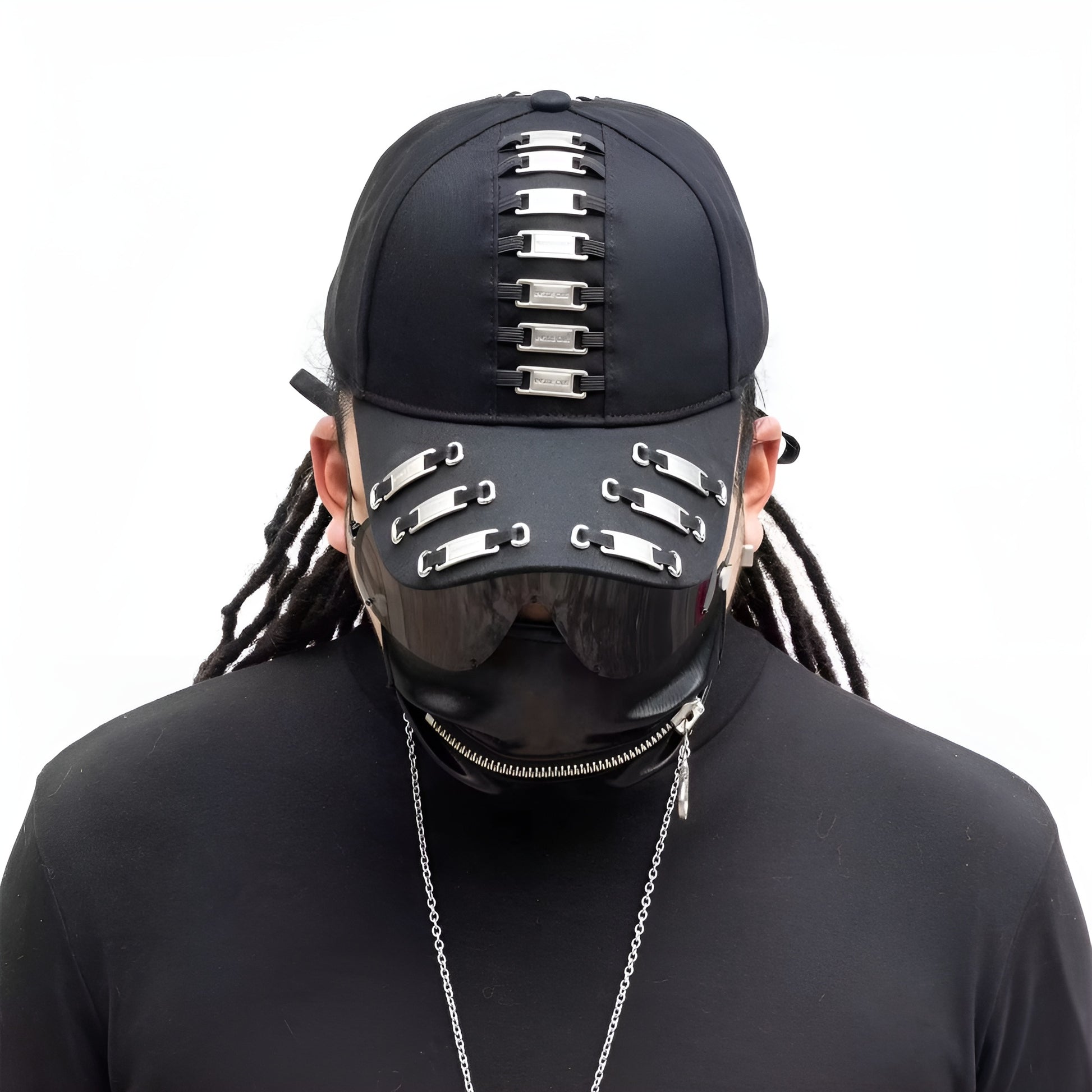 A model from Canada wearing a black darkwear cap with metal frame tags, shown from the front. 