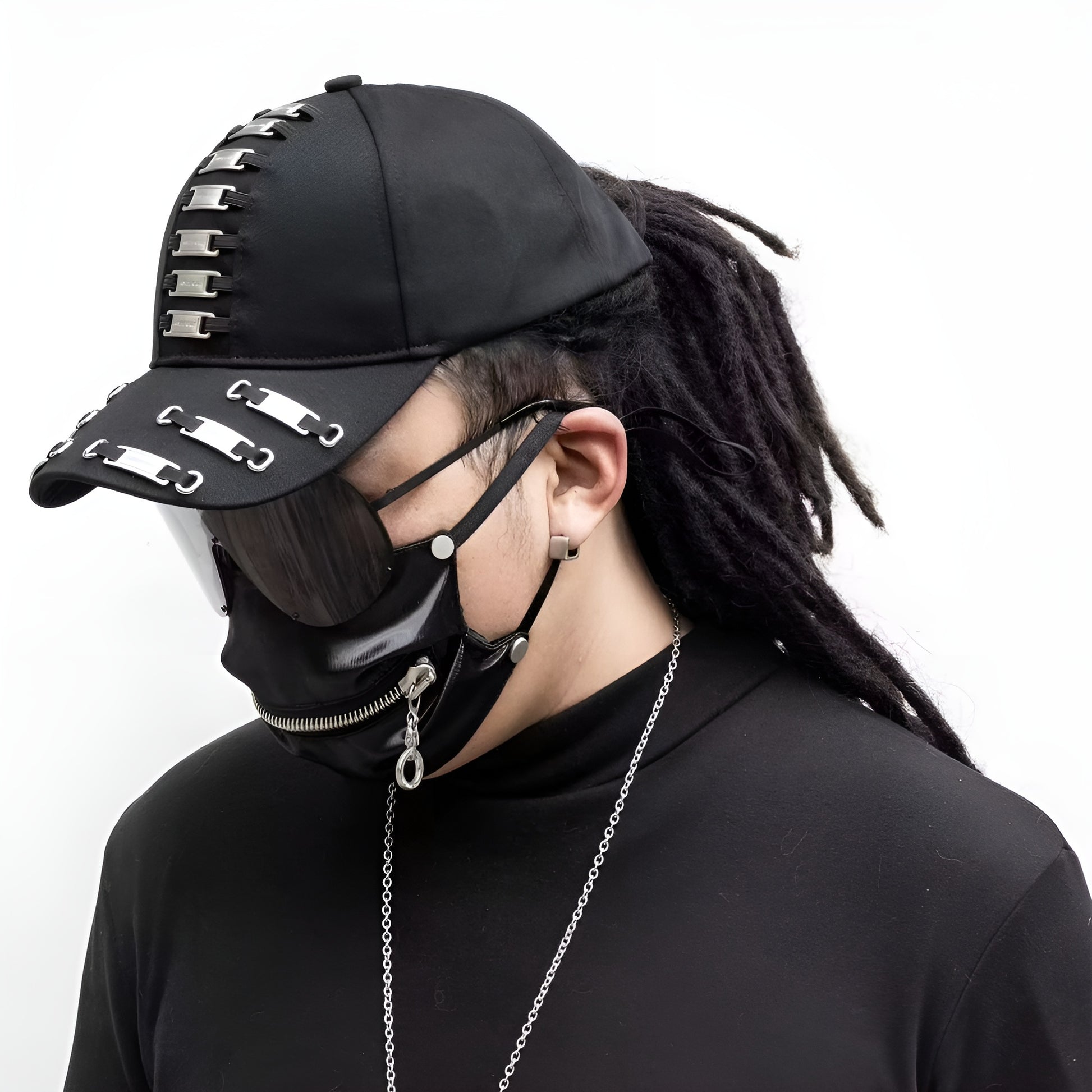 A Canadian model wearing a black darkwear cap with metal frame tags, viewed from the side. 