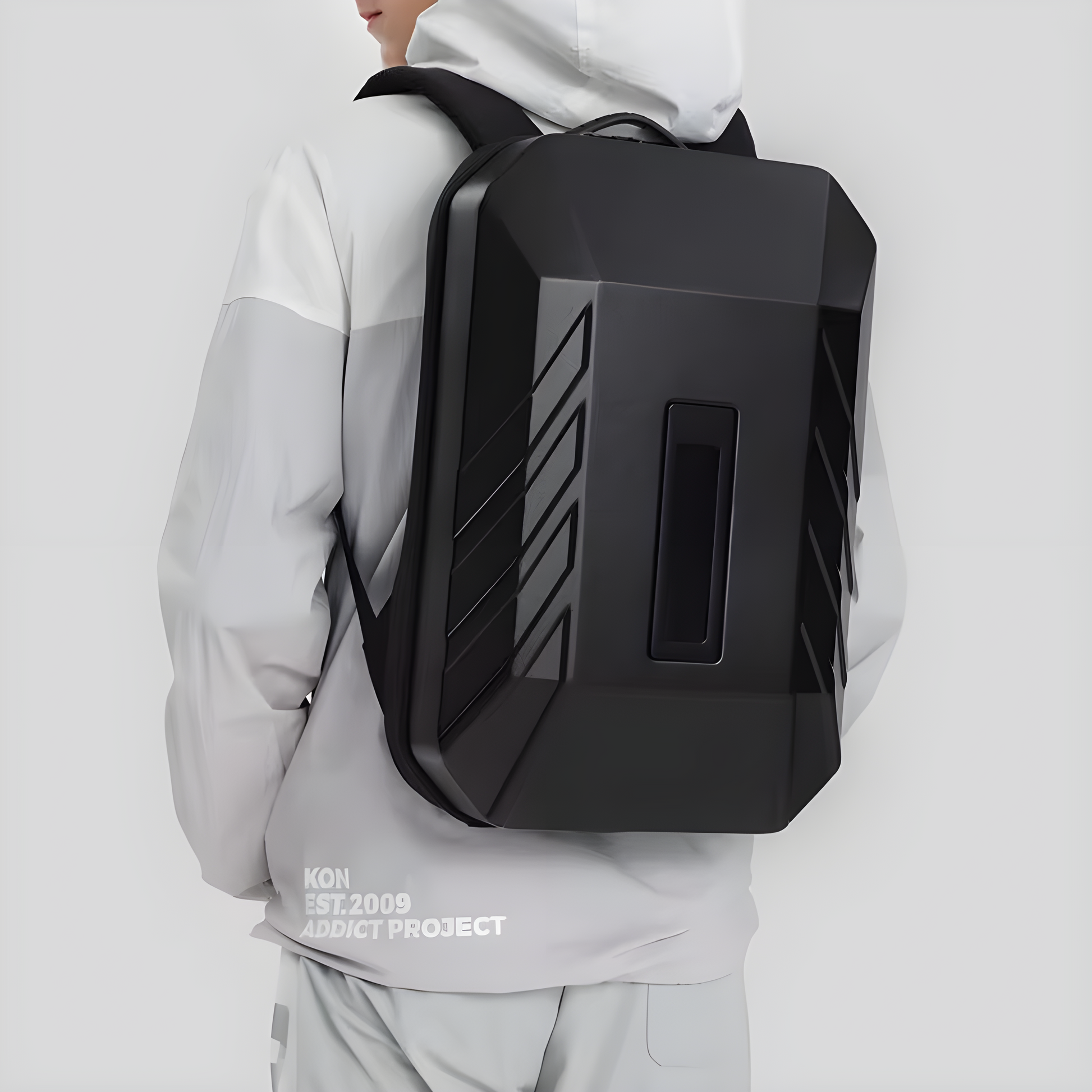 Front view of a person wearing a black hardshell anti-theft backpack with a cyberpunk design, demonstrating how the backpack looks when worn Canada.