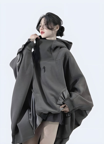 A woman wearing an oversized techwear hoodie, shown from the front side view in the Canada.