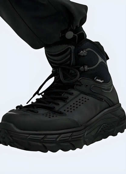 Side view of a person wearing techwear snow boots, showcasing the functional design, durable materials, and modern aesthetics suitable for outdoor winter adventures.