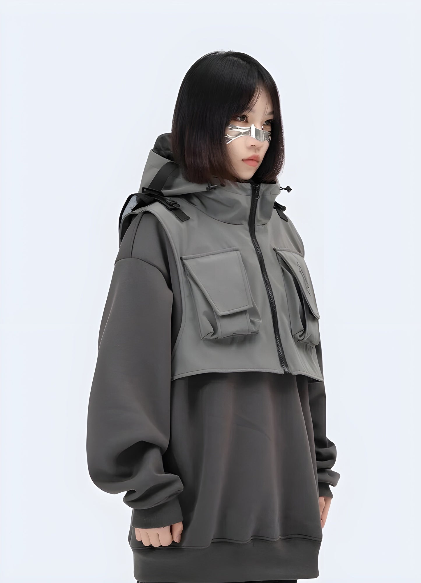 Front side view of a woman wearing a techwear hoodie jacket, showcasing its practical design and contemporary aesthetics for city life in the Canada.