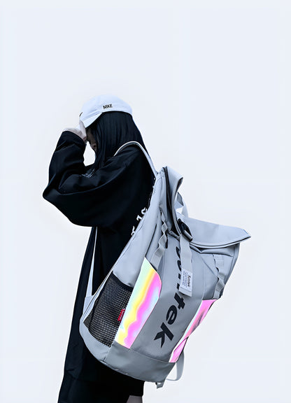 A woman wearing a grey reflective backpack, viewed from the side. The backpack features a shiny, reflective surface and a sleek, modern design Canada.