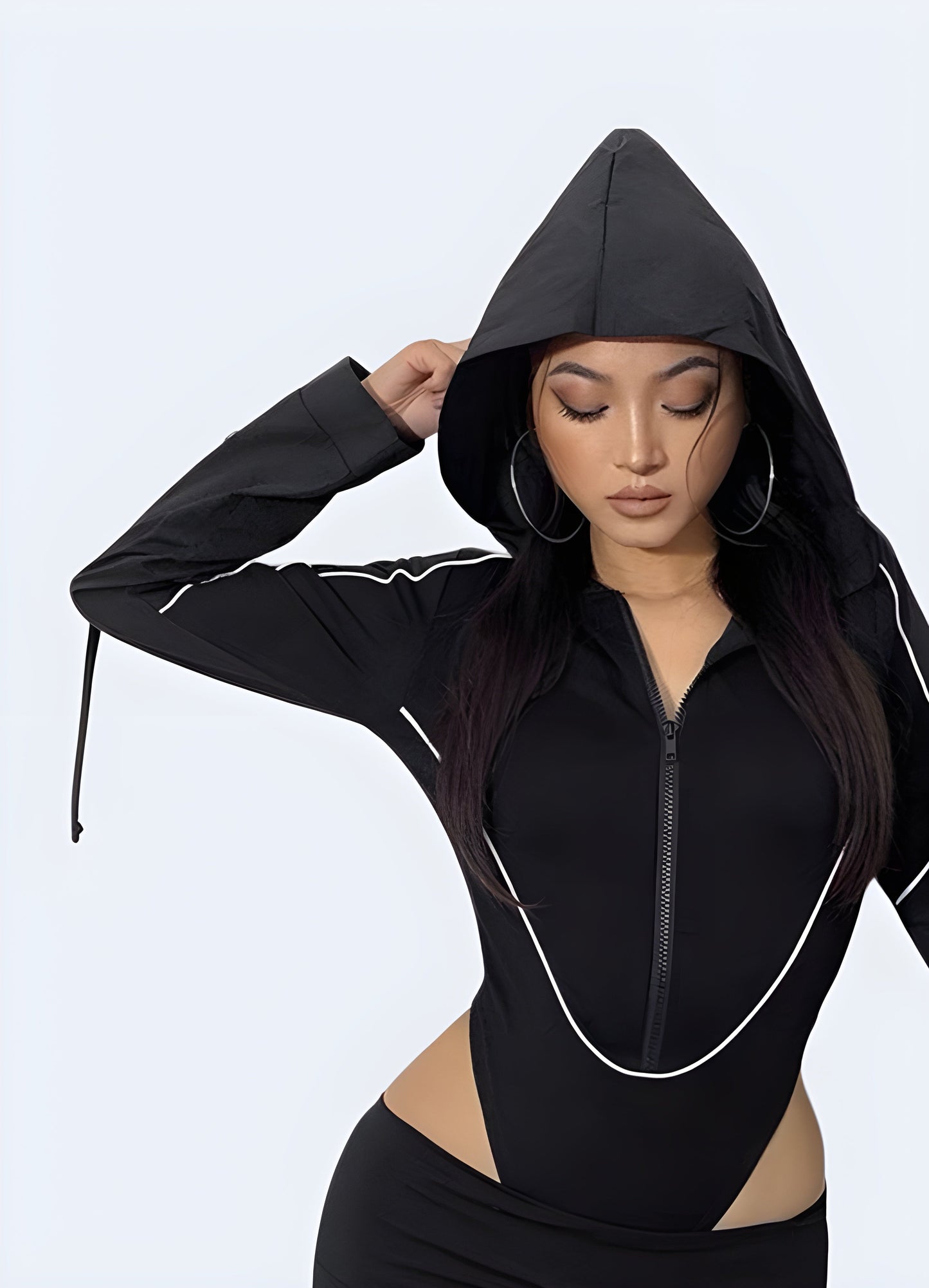 Front view of a woman wearing a trendy black hoodie bodysuit, showcasing its versatility and contemporary appeal for Canada wearers.