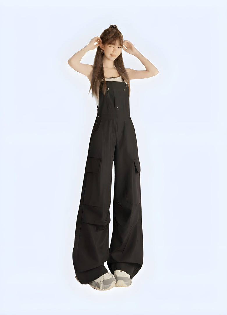 Woman wearing black techwear overalls with multiple pockets and straps, photographed from behind in an urban Canadian setting.