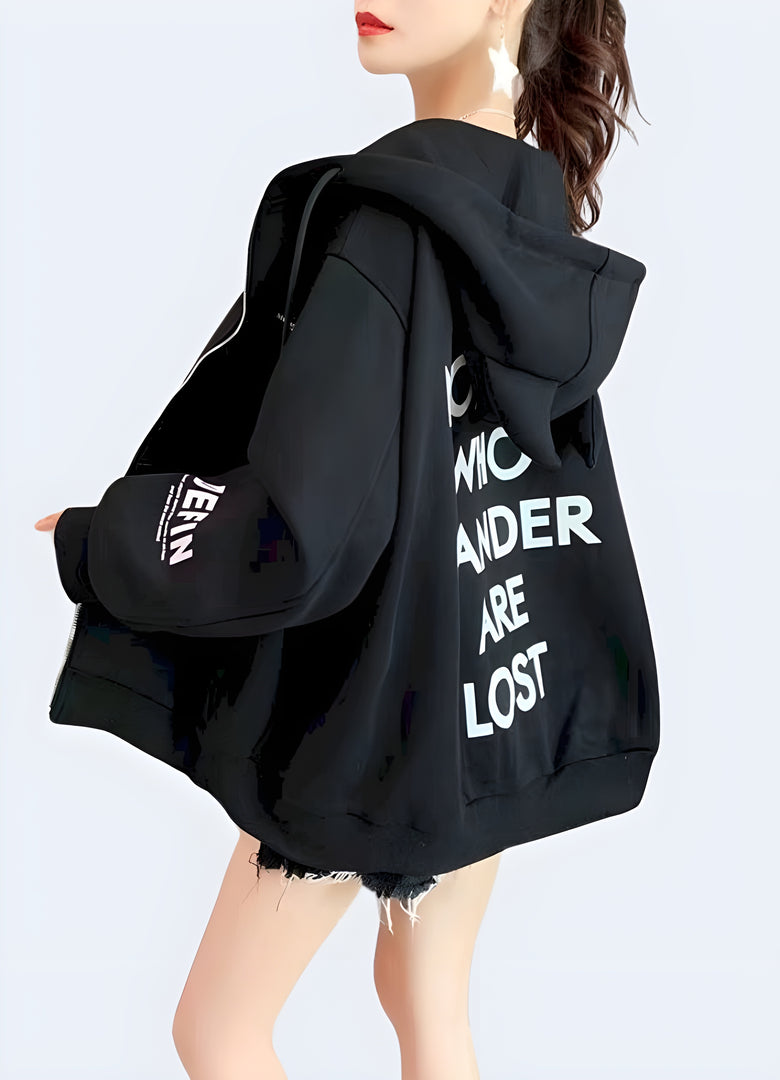 Woman wearing a women's techwear black hoodie with horns, showing a unique back view in a Canadian city.