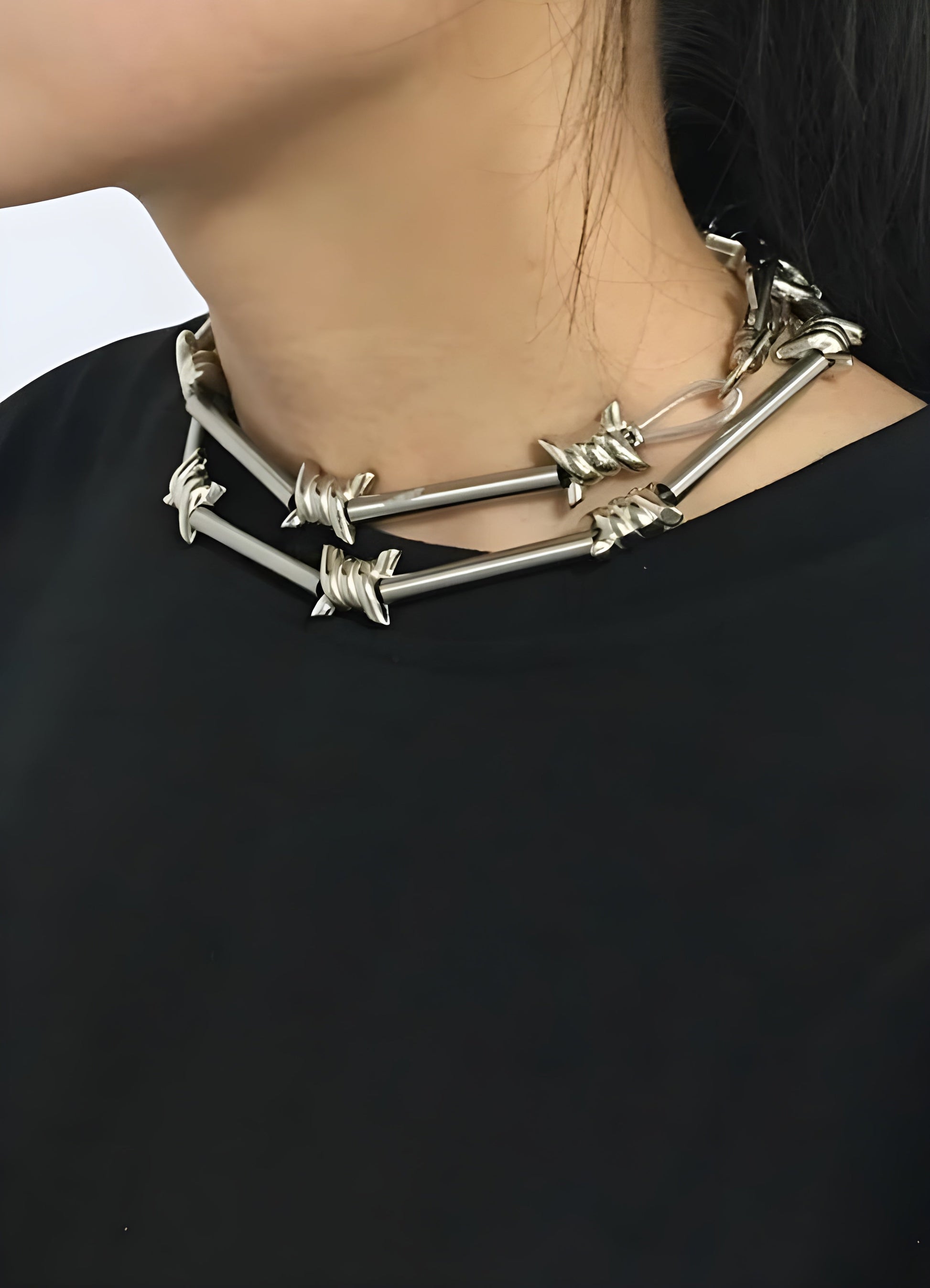 Front view of a woman wearing a barbed wire chain necklace in the Canada.