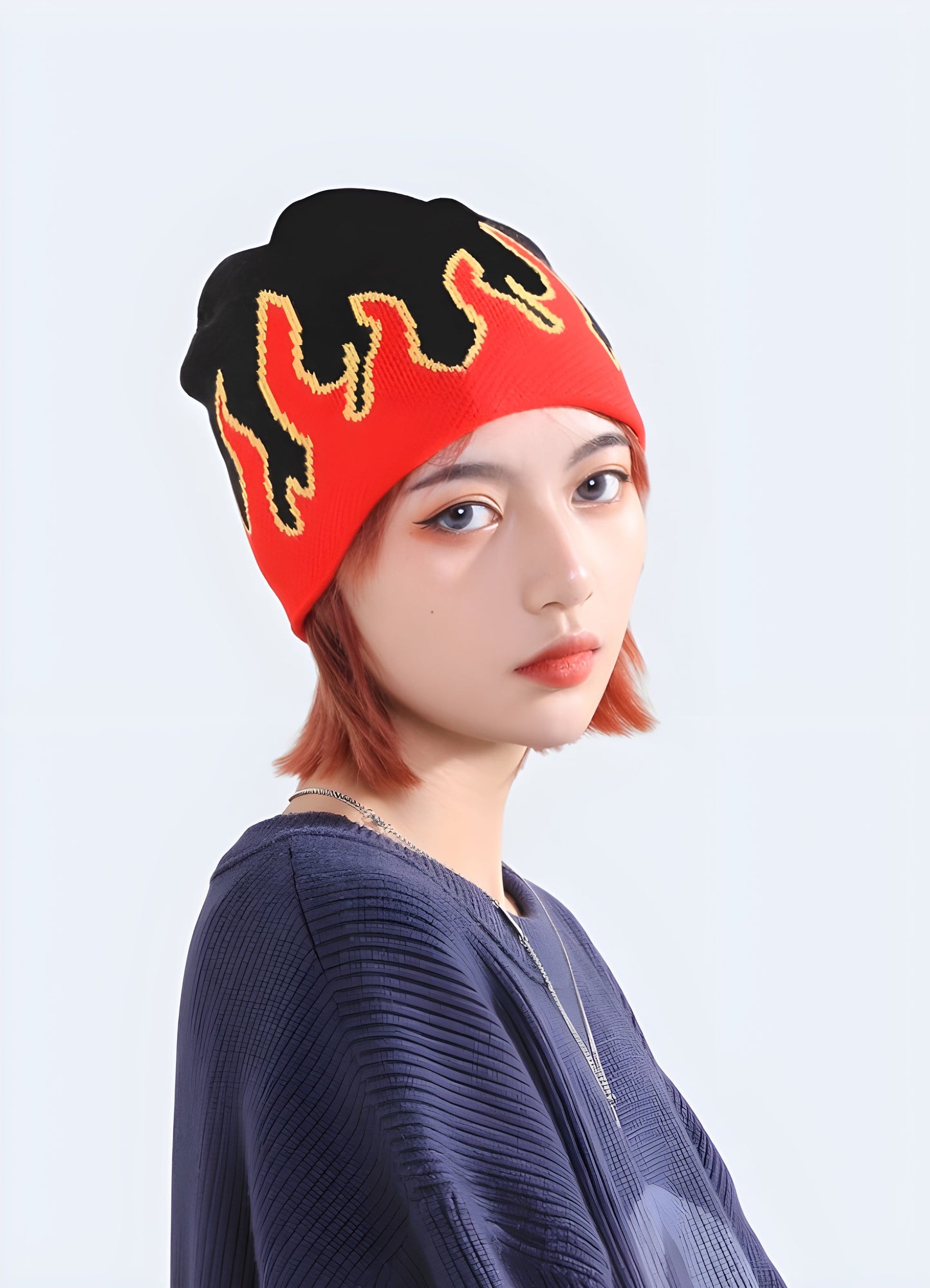 Woman wearing a beanie with flames, front view, in a model pose, showing the beanie's snug fit and bold flame design, available in Canada.