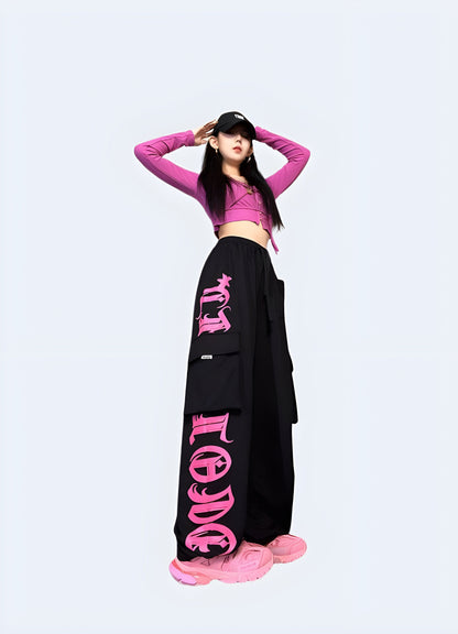 Right side view of a woman wearing black and pink techwear pants, highlighting the fashionable and functional style ideal for everyday wear in the Canada.