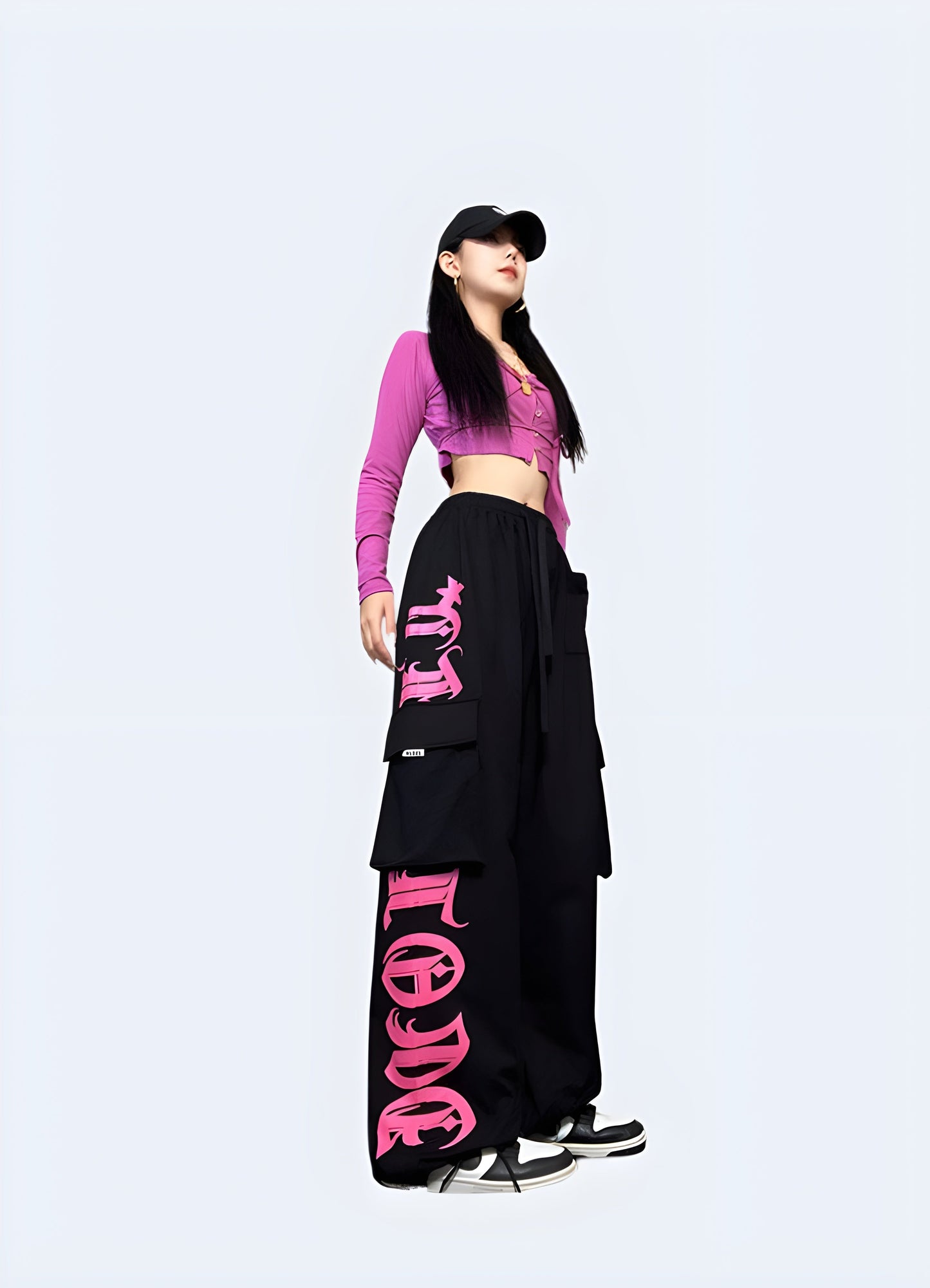 Right side view of a woman wearing black and pink techwear pants, highlighting the fashionable and functional style ideal for everyday wear in the Canada.