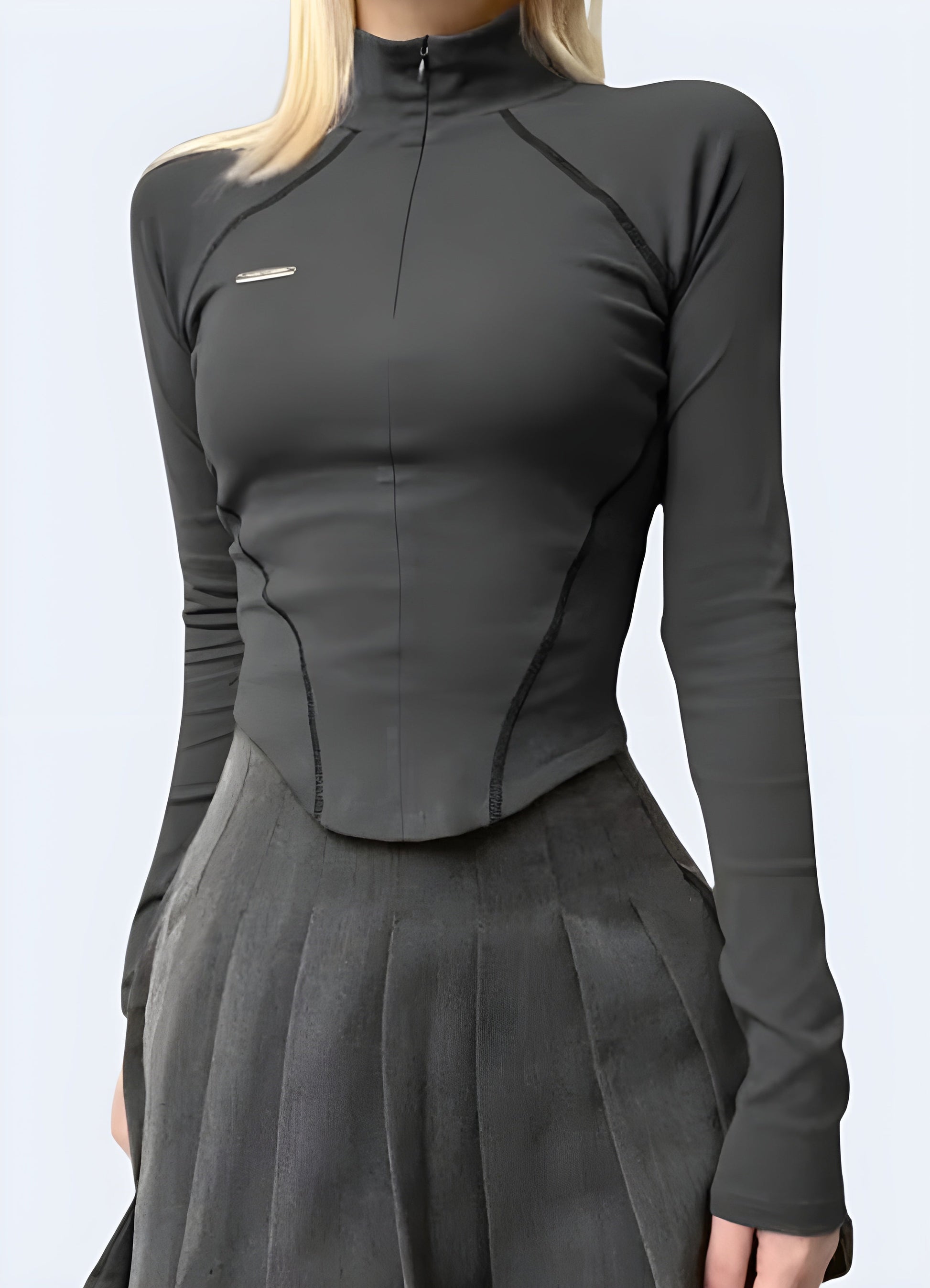 Front view of a woman wearing a grey techwear long sleeve shirt, perfect for contemporary street style in Canada.