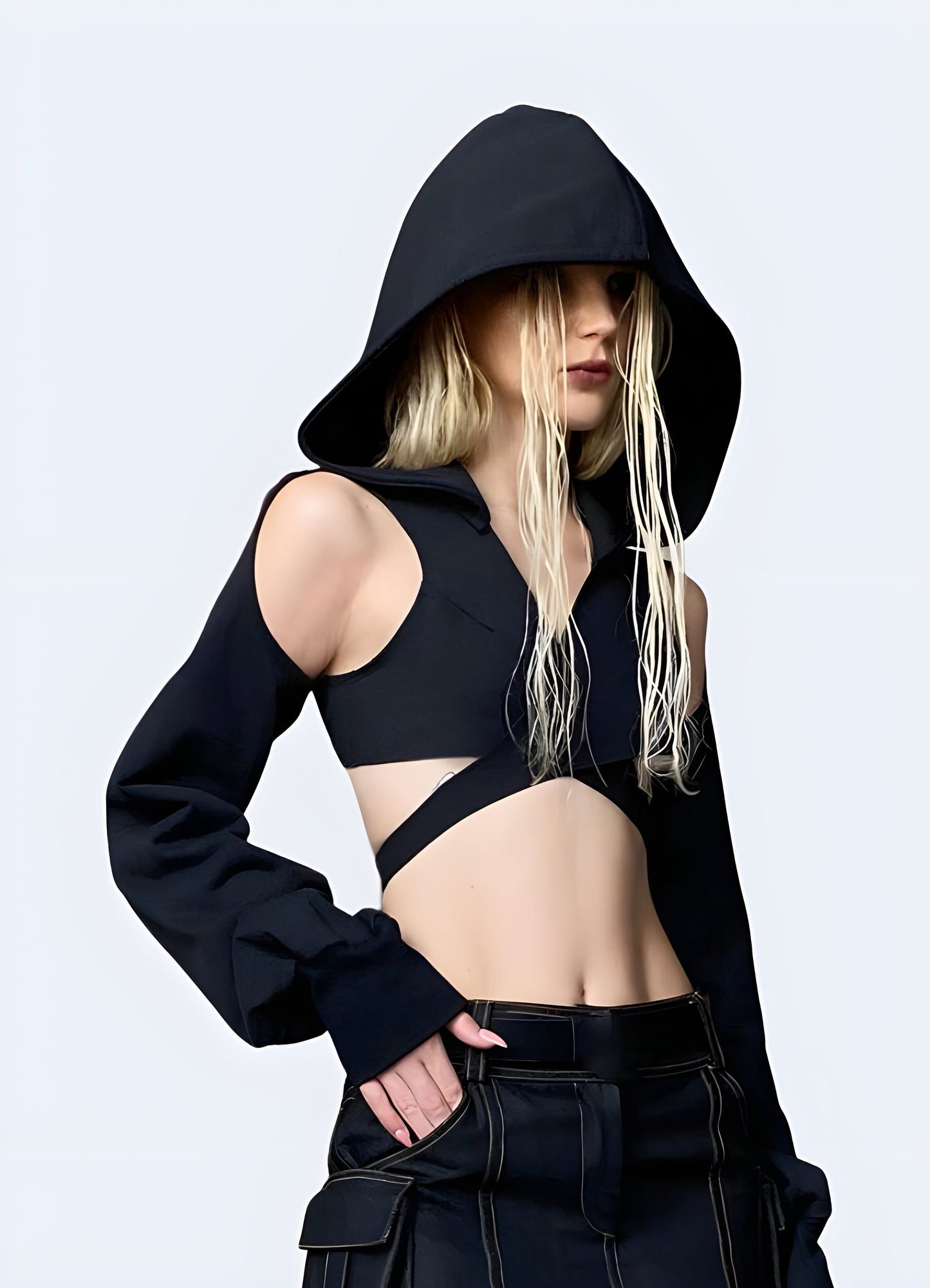 Front view of a woman wearing a techwear women's darkwear hood crop top, showcasing contemporary street style in Canada.