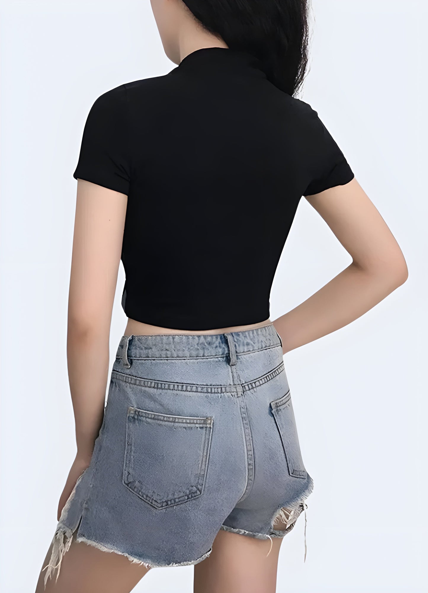 Back view of a woman wearing a techwear buckle crop top, showcasing its eye-catching buckle detail and modern silhouette for fashion-forward women in the Canada.