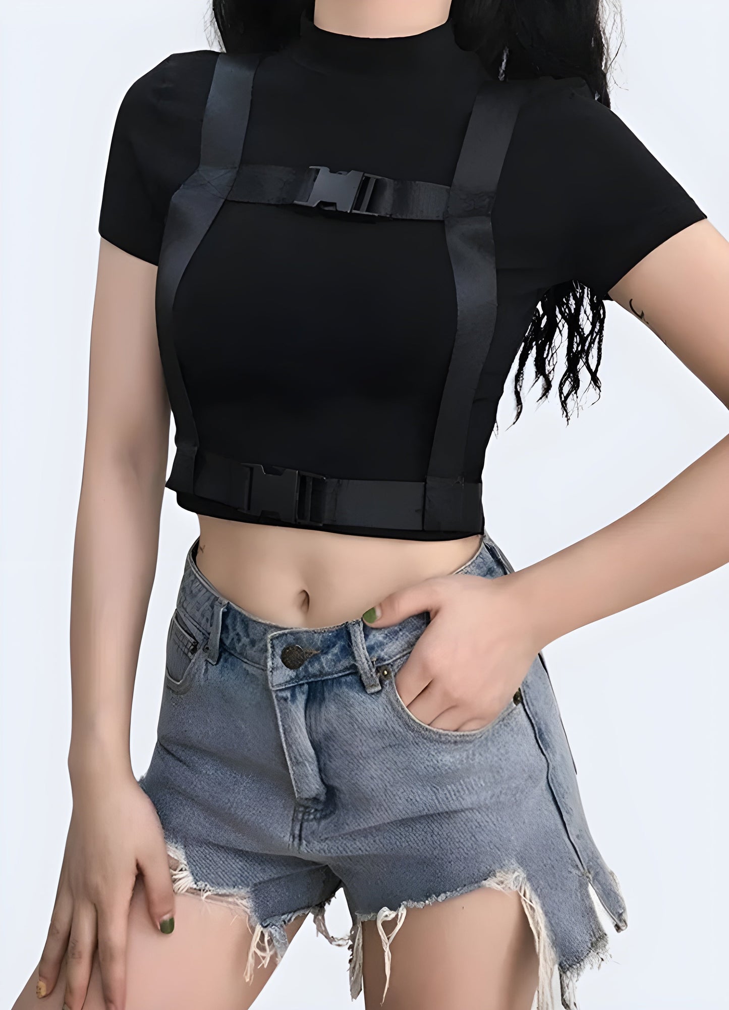 Front view of a woman wearing a stylish techwear buckle crop top, showcasing contemporary urban style in Canada.