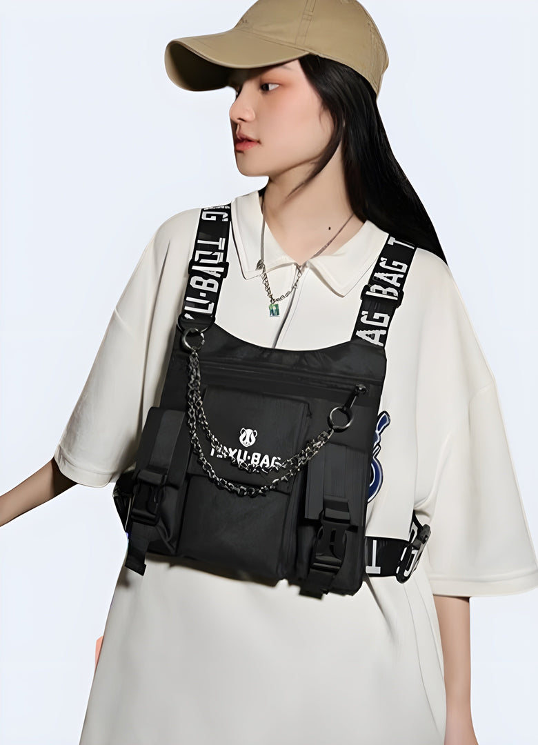 The front view highlights the bag’s modern, utilitarian style and how it fits comfortably across her chest, complementing her techwear-inspired outfit Canada.