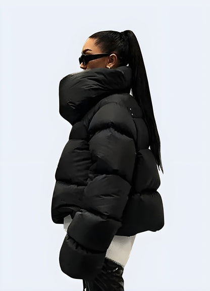 Side view of a woman wearing a techwear down puffer jacket, showcasing its sleek silhouette and functional features for cold weather in the  Canada.