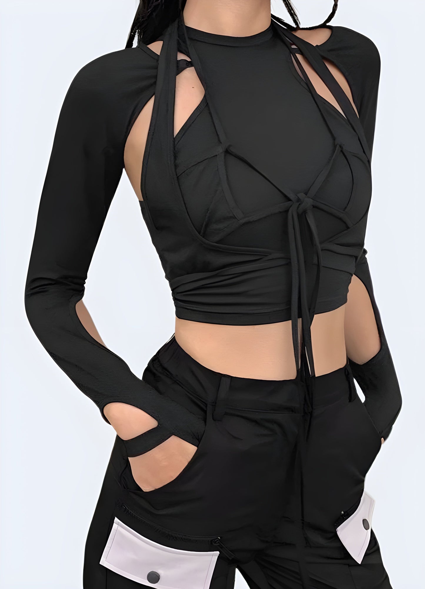 Front view of a woman wearing a fashionable techwear lace-up crop top, showcasing contemporary style in Canada.