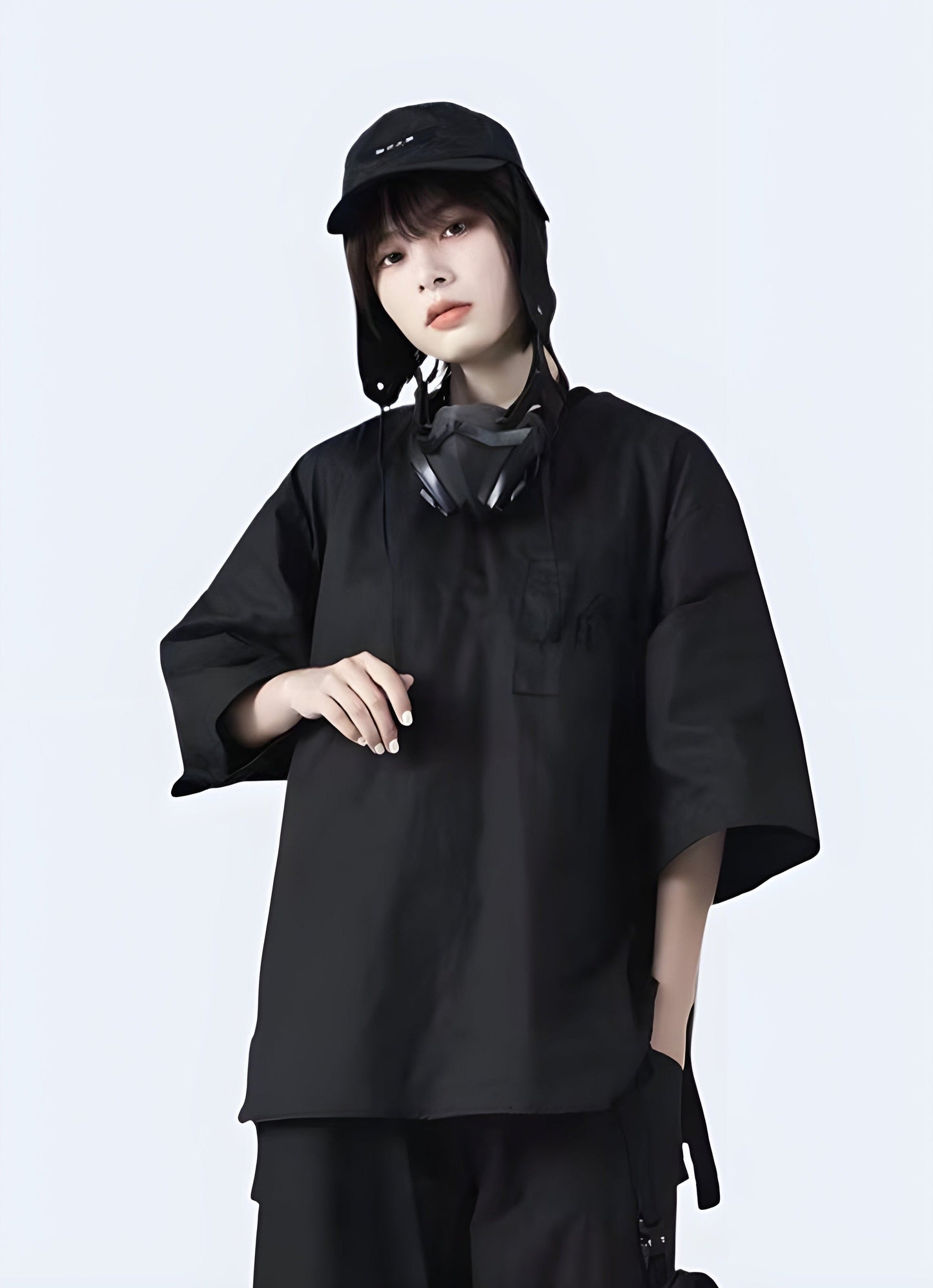 Front view of a woman wearing a techwear women's darkwear loose shirt, showcasing a stylish and contemporary look in Canada.