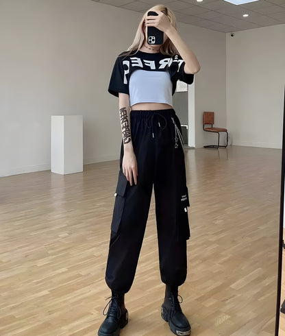 Model view of a woman wearing stylish techwear women's pants with a chain accent, showcasing the blend of fashion and utility popular in Canada street style.