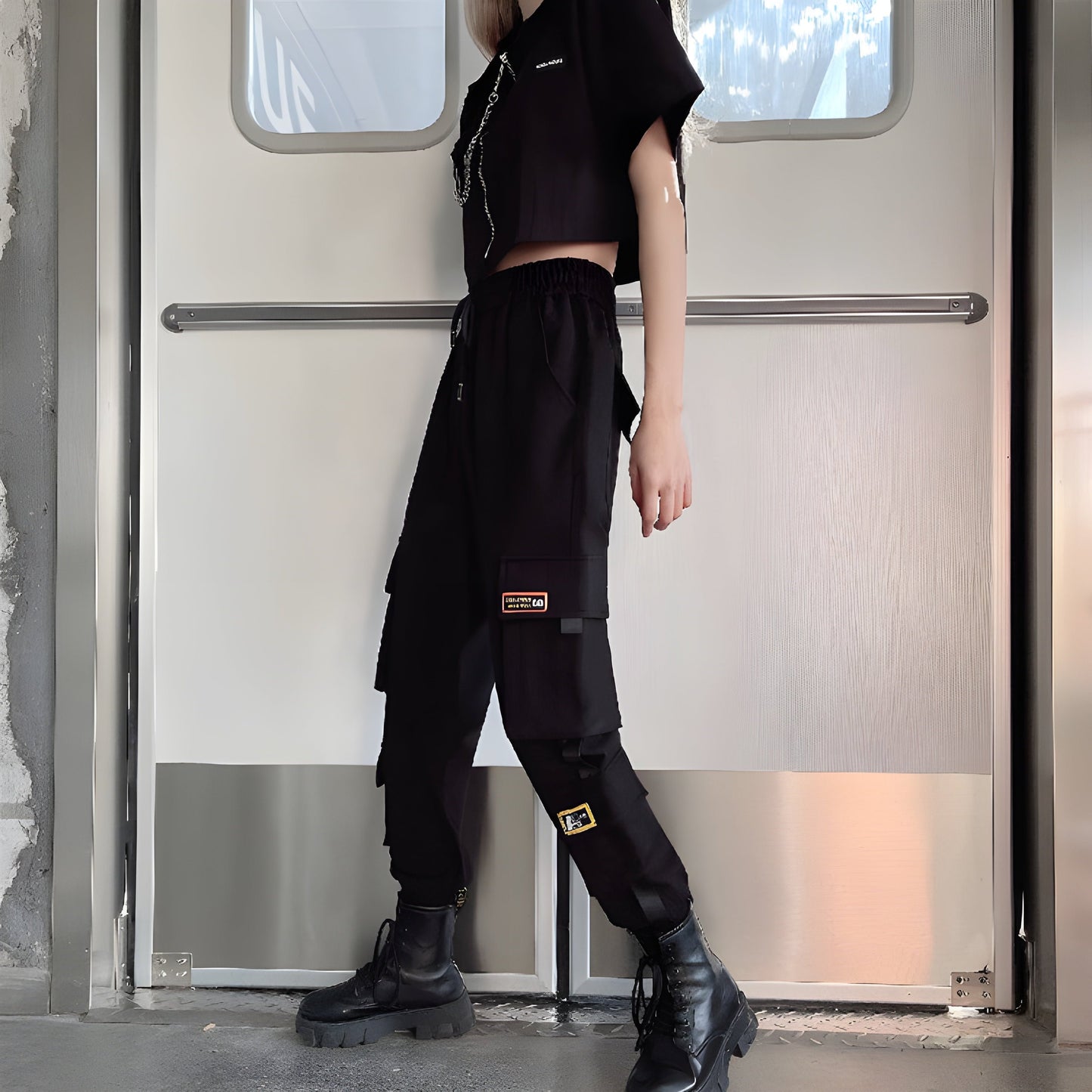 Side view of a woman wearing form-fitting womens techwear pants with adjustable hem,, highlighting the comfort and versatility of this popular style in the Canada.