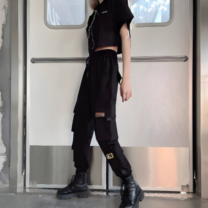 Side view of a woman wearing form-fitting womens techwear pants with adjustable hem,, highlighting the comfort and versatility of this popular style in the Canada.