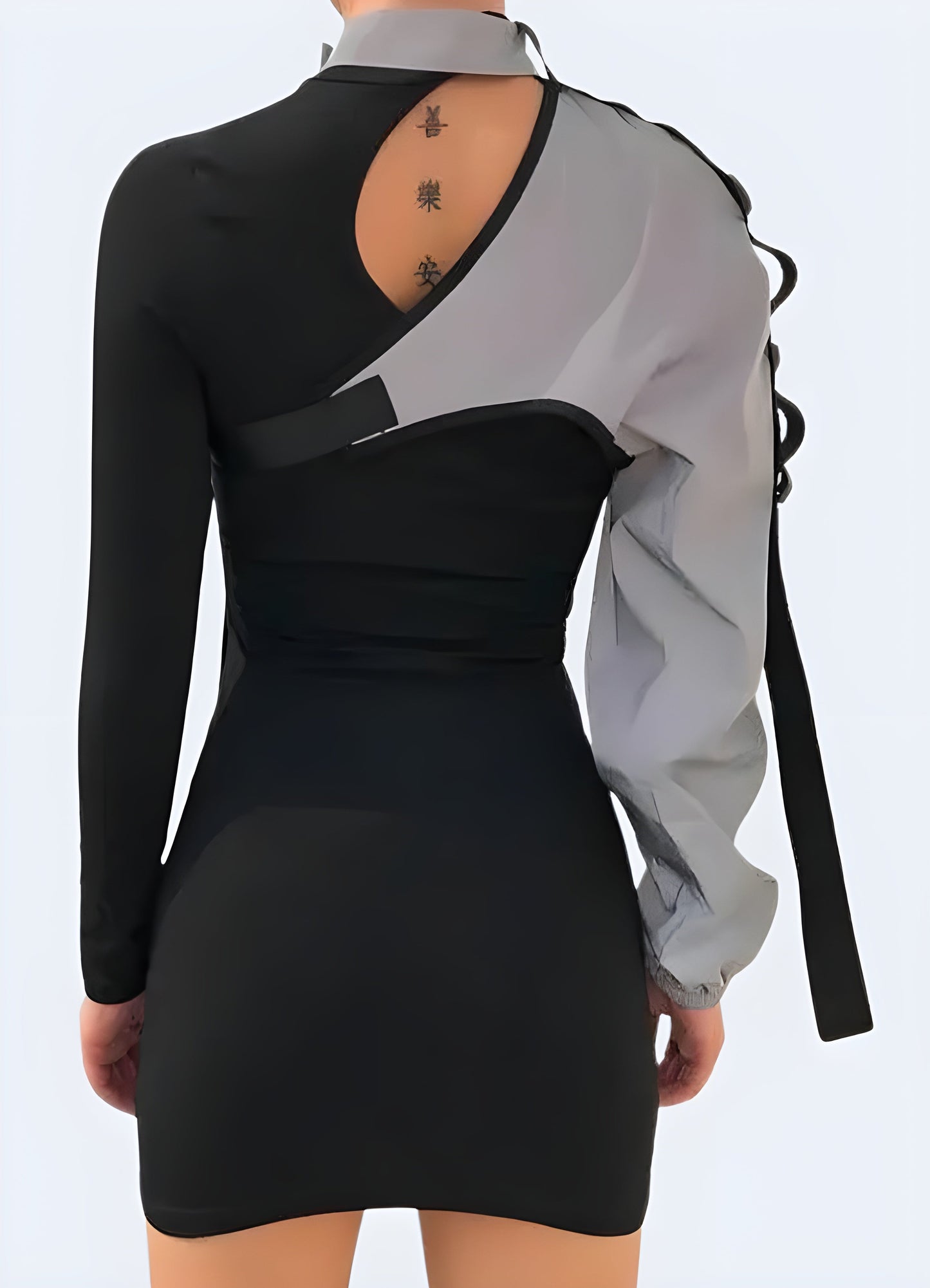 Back view of a woman wearing a one-sleeve reflective top, showcasing its unique asymmetrical design and reflective properties for safety and style in the Caada.