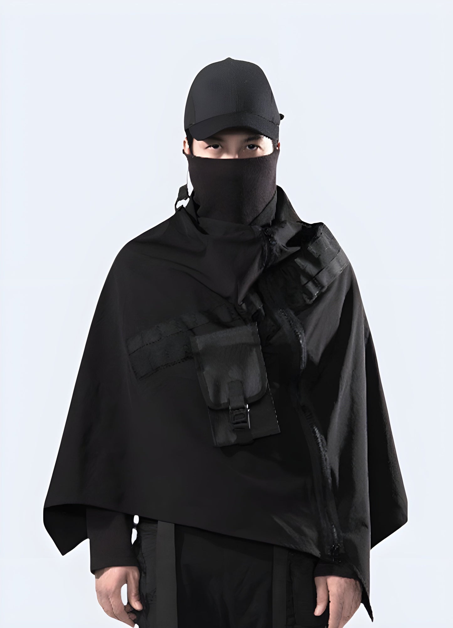 Modern techwear poncho with a zipper, showcased in a stylish, functional design, set against a Canadian backdrop. Ideal for urban and outdoor adventures.